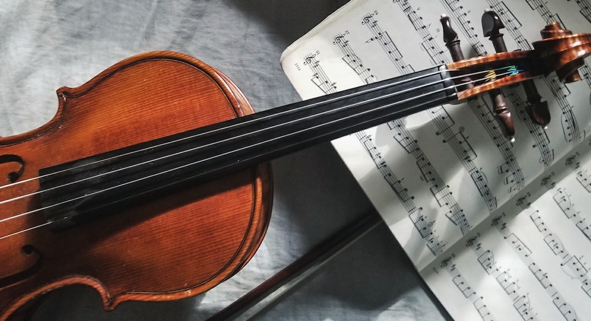 a violin lies on sheet music