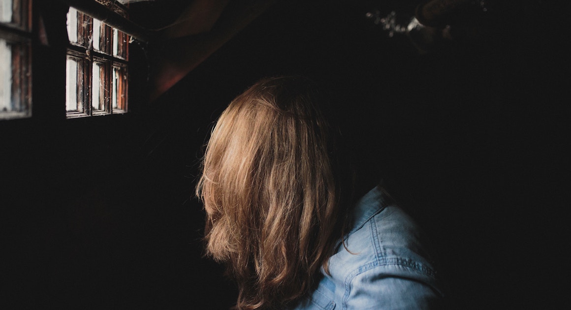 woman's face obscured by her hair
