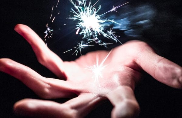hand with magic sparkle above it