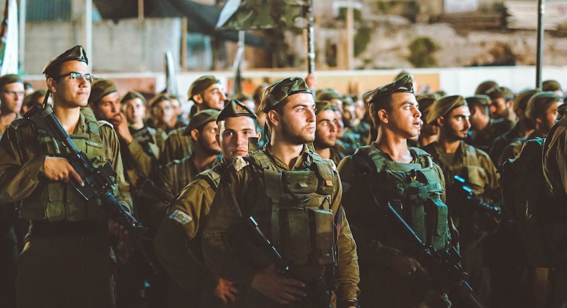 soldiers holding weapons standing together