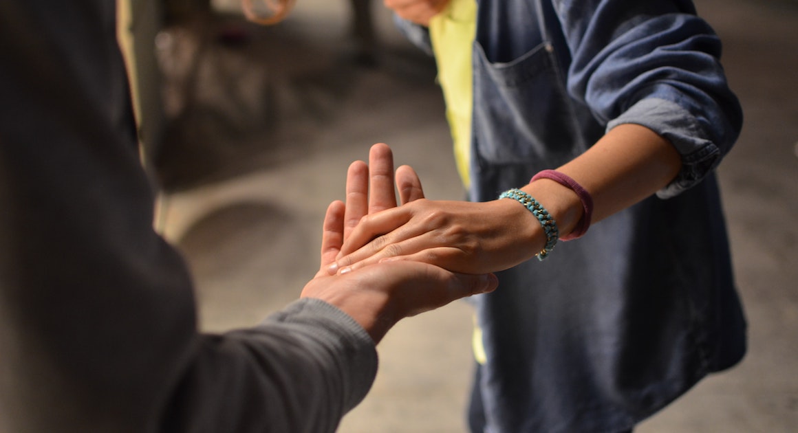 a man and woman hold hands