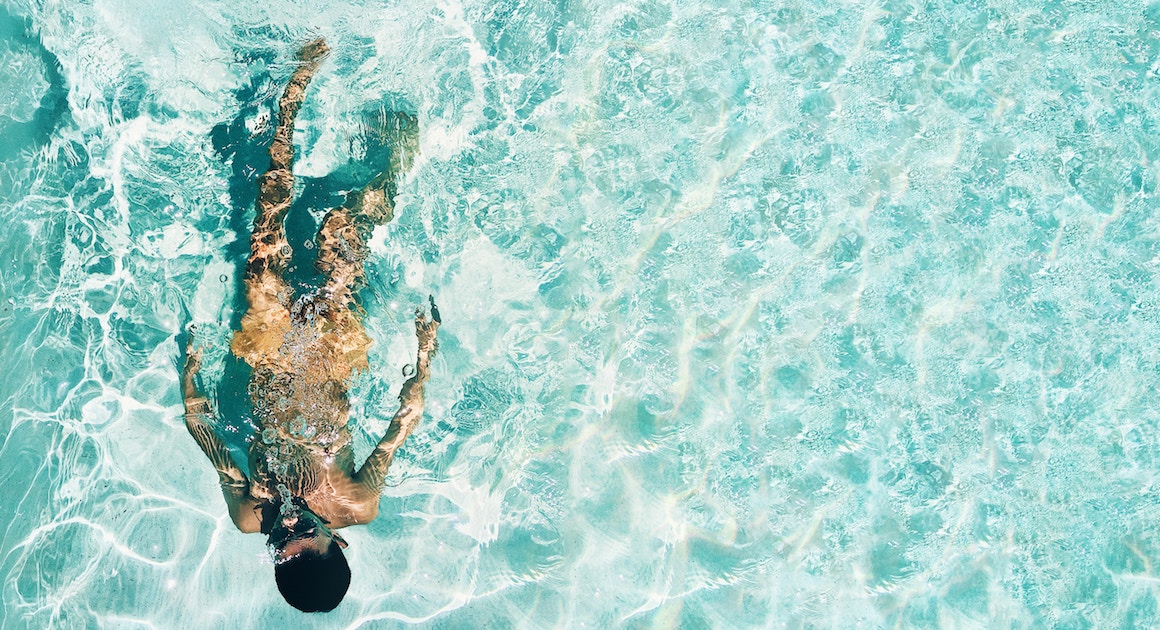 swimmer in a pool in the sun