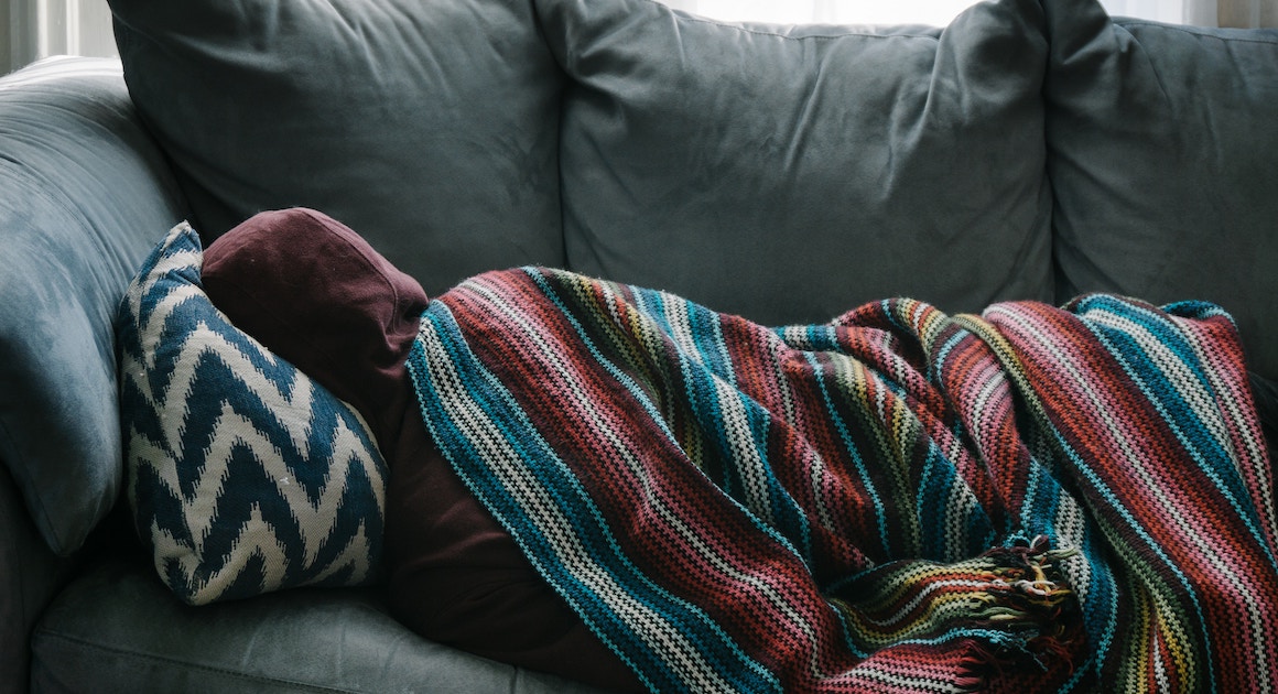 sick person lying on a couch