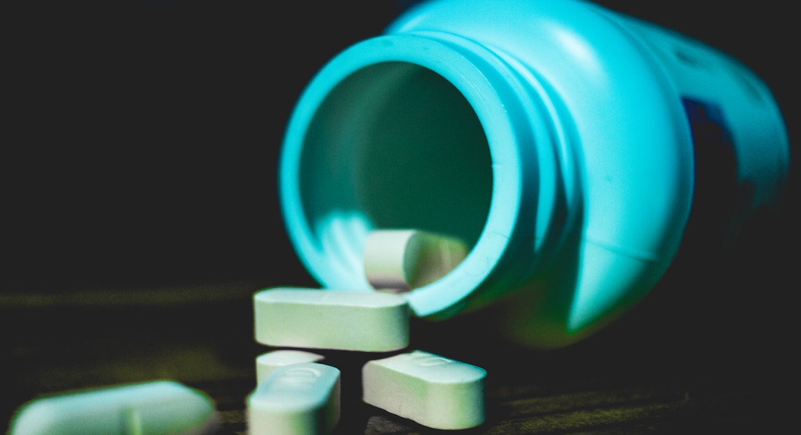 pill bottle spilling pills onto a table