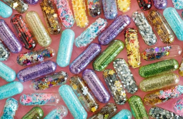 multi-colored drug capsules on a desk