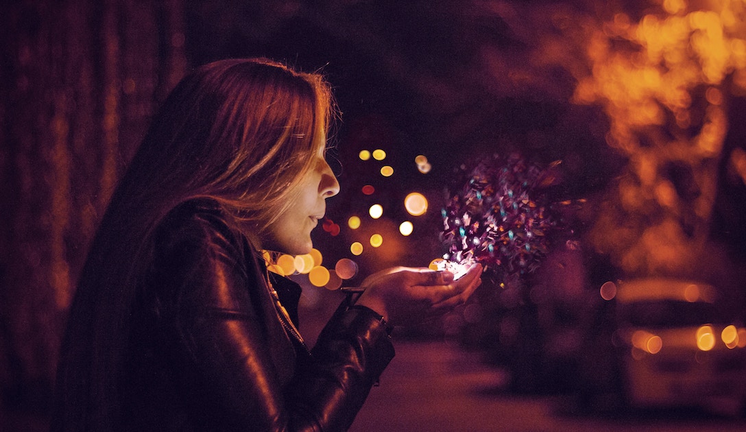 woman blowing magic dust