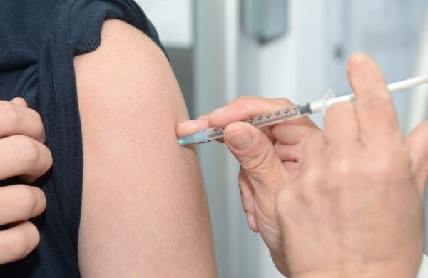 giving an immunization in an arm