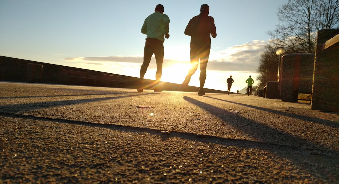 two men run with the sunrise